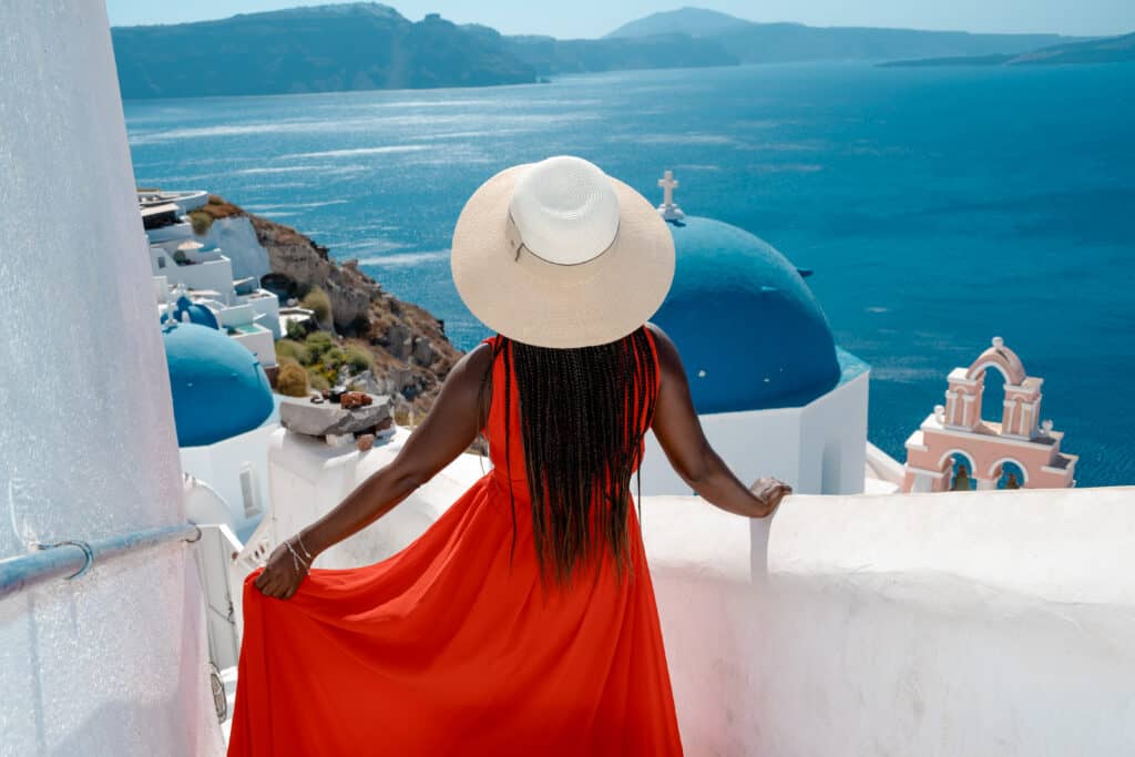 Black woman in Santorini in red dress
