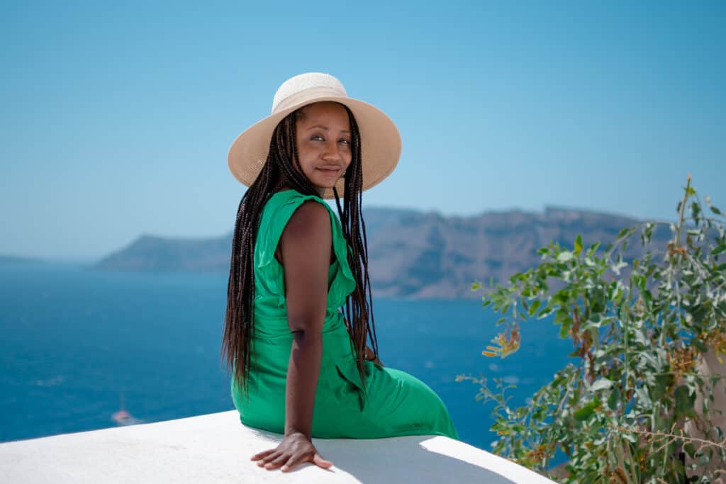 Black woman in Santorini in green dress