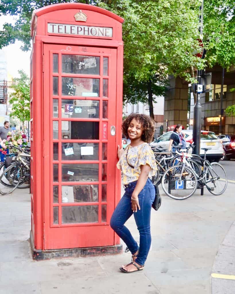 Black Woman by Red Telephone Booth